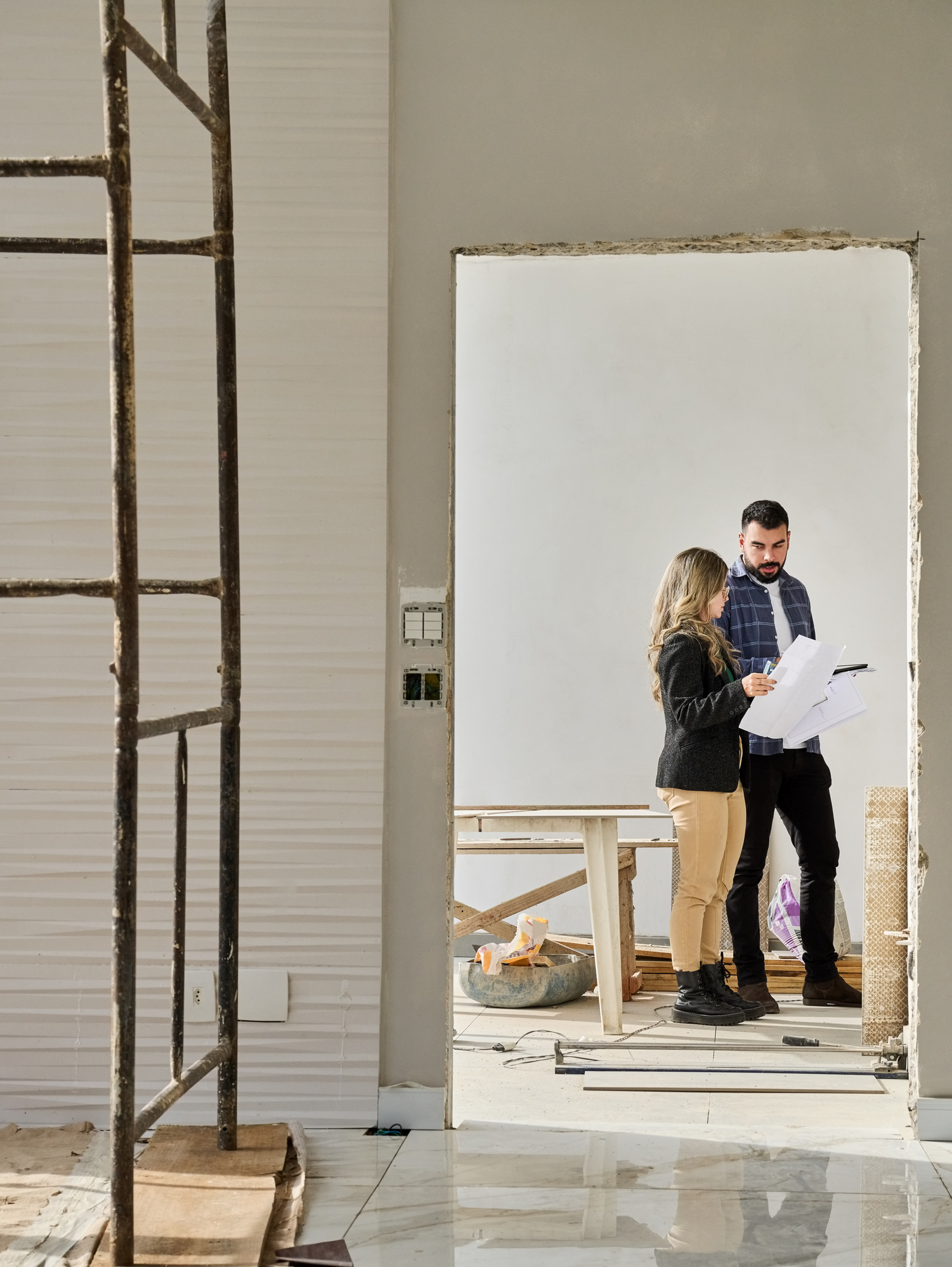 Contractor consulting with a homeowner in a partially finished build. 